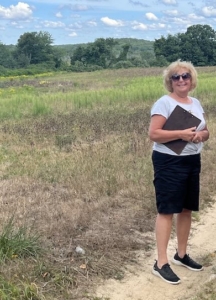 Brenda Woodward visting a future founder plot